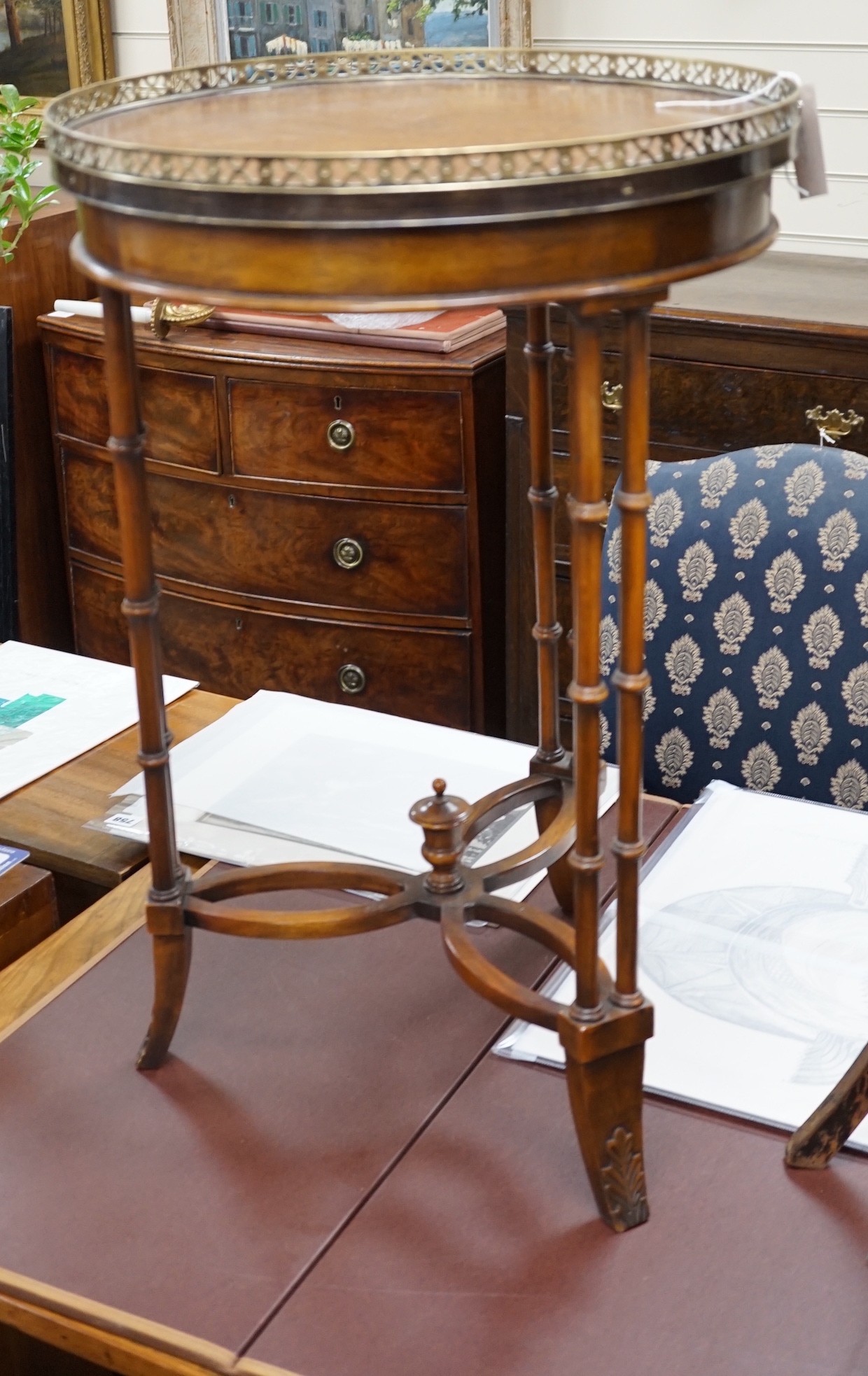 A leather topped mahogany occasional table with brass gallery, diameter 46cm *Please note the sale commences at 9am.